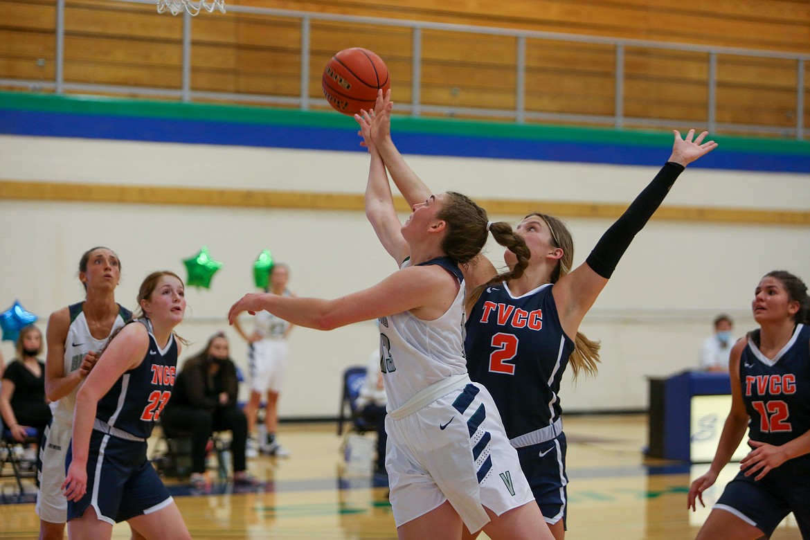 Big Bend’s Kelsey Sorenson scoops under the defender to get the shot away near the rim in the second half of the 71-68 win on Saturday.