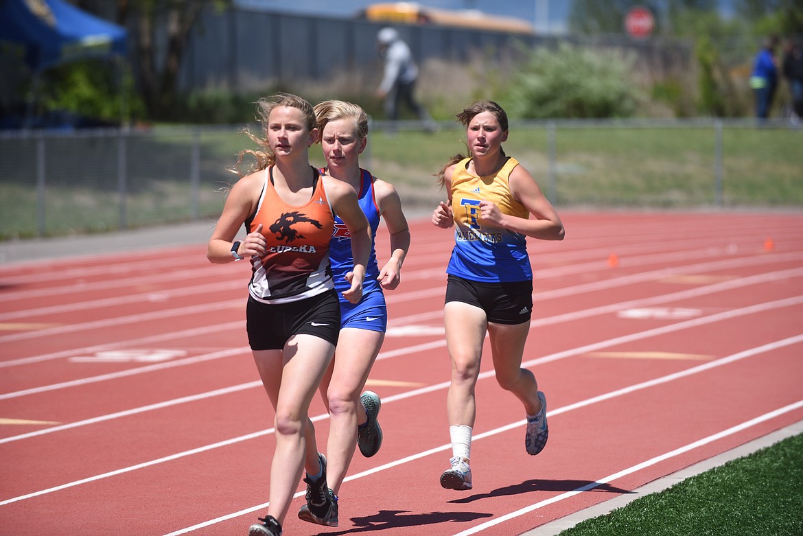 Thompson Falls freshman Faith Palmer, running in the 1,600-meter run at last week’s Class B divisional meet in Missoula behind Eureka’s Taylor Lancaster and Bigfork’s Grace Stewart, placed third in it and the 3,200-meter run. Palmer had personal best performances in each event and qualified for this week’s state meet. (Scott Shindledecker/Valley Press)