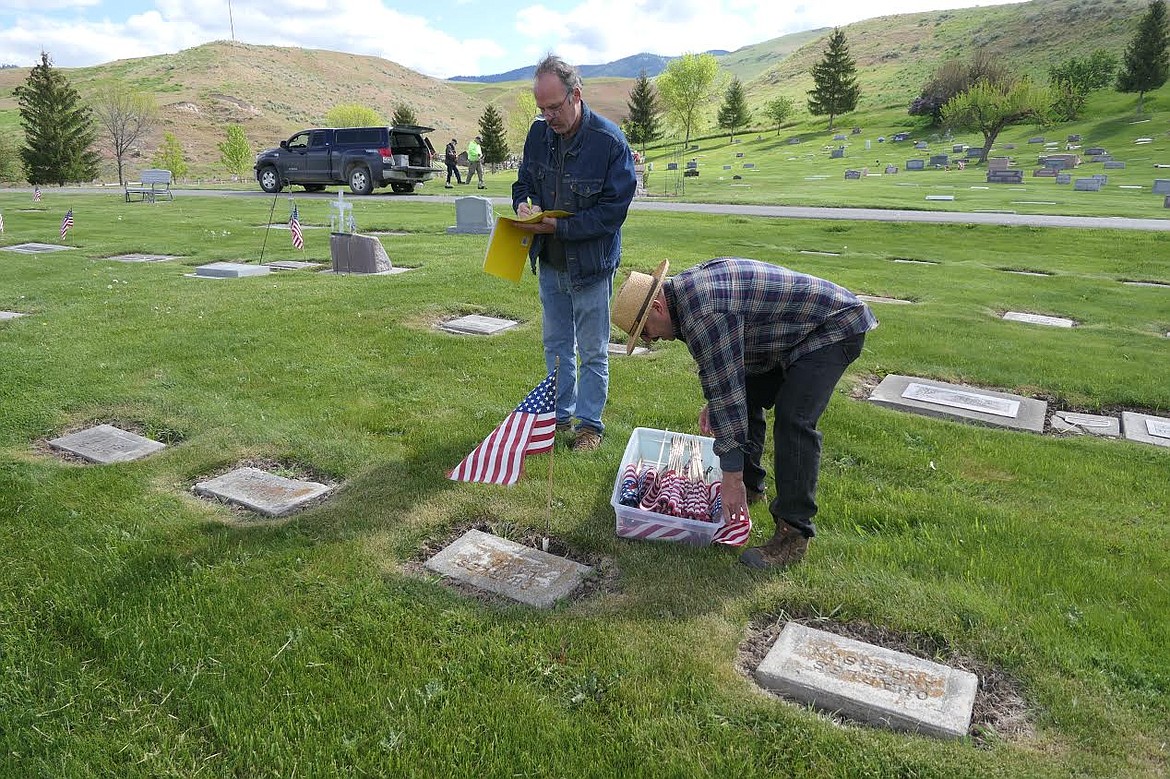 Members of the Plains VFW and the VFW Auxiliary, as well as other members of the community, gathered at the Plains Cemetery Saturday, May 22, to plant flags on the graves of fallen veterans and VFW Auxiliary members. The veterans had the American flag planted by their headstones and members of the VFW Auxiliary had blue flags. Participants included those of all ages. The VFW in Plains has been planting flags on the headstones of military men and women since the post was established in 1938. (Adam Lindsay/Valley Press)