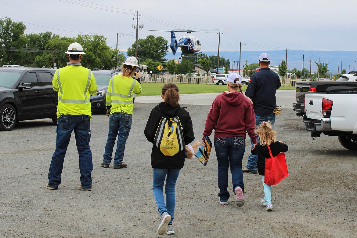 A crowd gathers around a landing Airlift Northwest helicopter at the Be Ready Expo on Saturday.