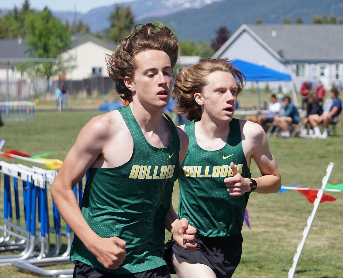 Bulldogs Deneb Linton and Jacob Henson compete in the men’s 3200 meter run on Saturday at Columbia Falls. Both ran personal bests and qualified for the state meet. (Matt Weller photo)