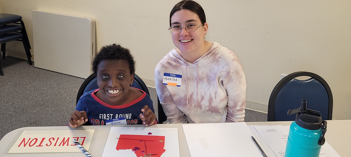 Volunteer Marissa Palazzo and 8-year-old Ezra Wright smile for the camera Saturday during the first My Environment activity day. My Environment is a new group for visually impaired youths to learn more about the world around them, starting with Idaho.
