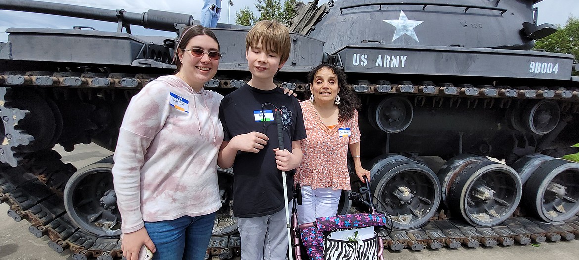 From left, Marissa Palazzo, 13-year-old Alex Owens and My Environment founder Jordana Engebretsen snap a photo Saturday in front of the tank at the Post Falls American Legion.