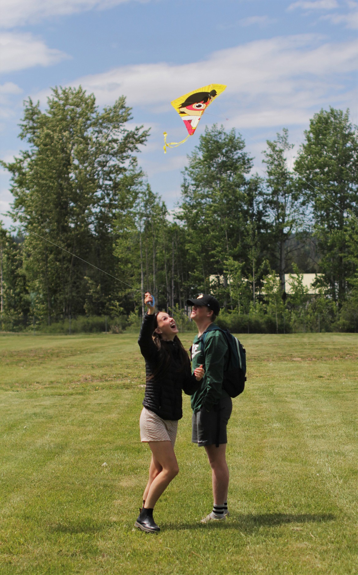 Erin Eddy (left) flies a kite as Lukas Genay-Wolf looks on Friday afternoon.