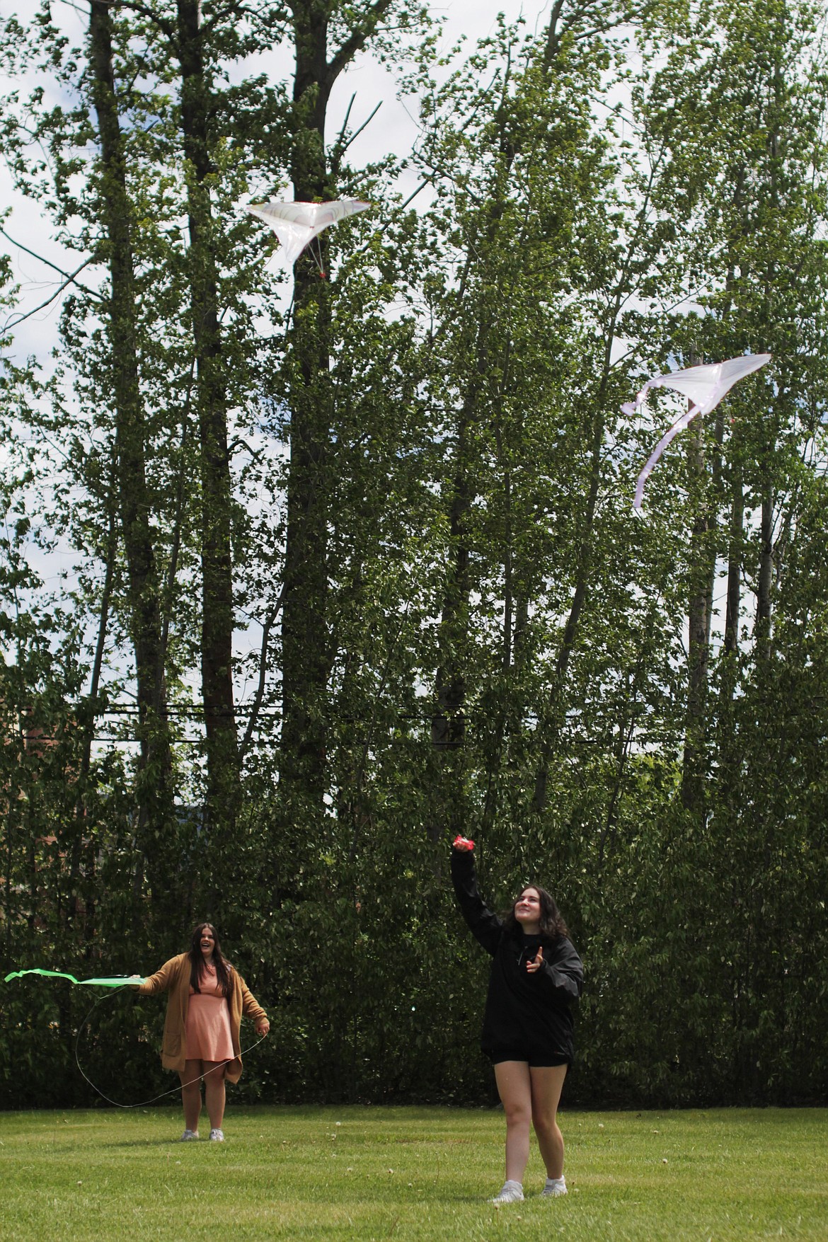 Mirabella Nizzoli (left) and Baxter Pollard fly kites Friday at Sandpoint High School.