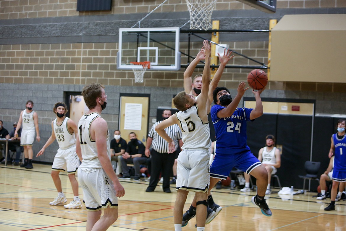 Warden High School's Hector De La Cruz (24) flies in for a layup in the second half against the Royal Knights on Monday night in Royal City.