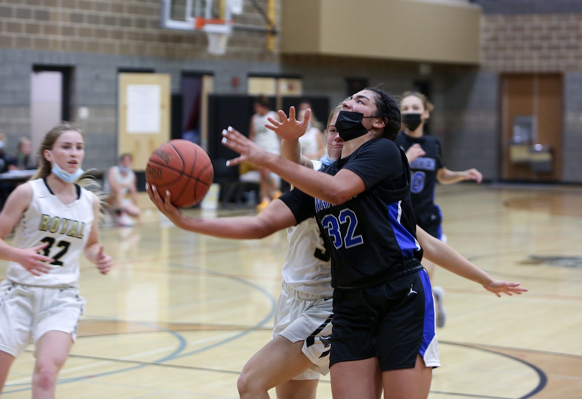 Warden High School's Kiana Rios powers her way into the lane to score in the second half against Royal High School on Monday night at the Royal Intermediate School gym.