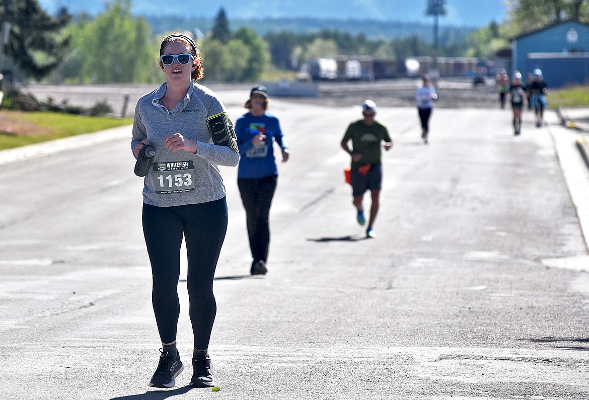 Maura Lammers of Spokane, Washington runs down Depot Street as she competes in the Whitefish Marathon on Saturday. She took sixth in her division of the full marathon. (Whitney England/Whitefish Pilot)