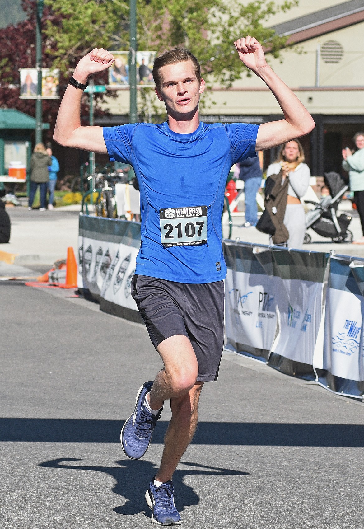 Adam McMonagle of Eagan, Minnesota runs across the finish line to take third overall in the mens division in the Whitefish Half Marathon on Saturday. (Whitney England/Whitefish Pilot)