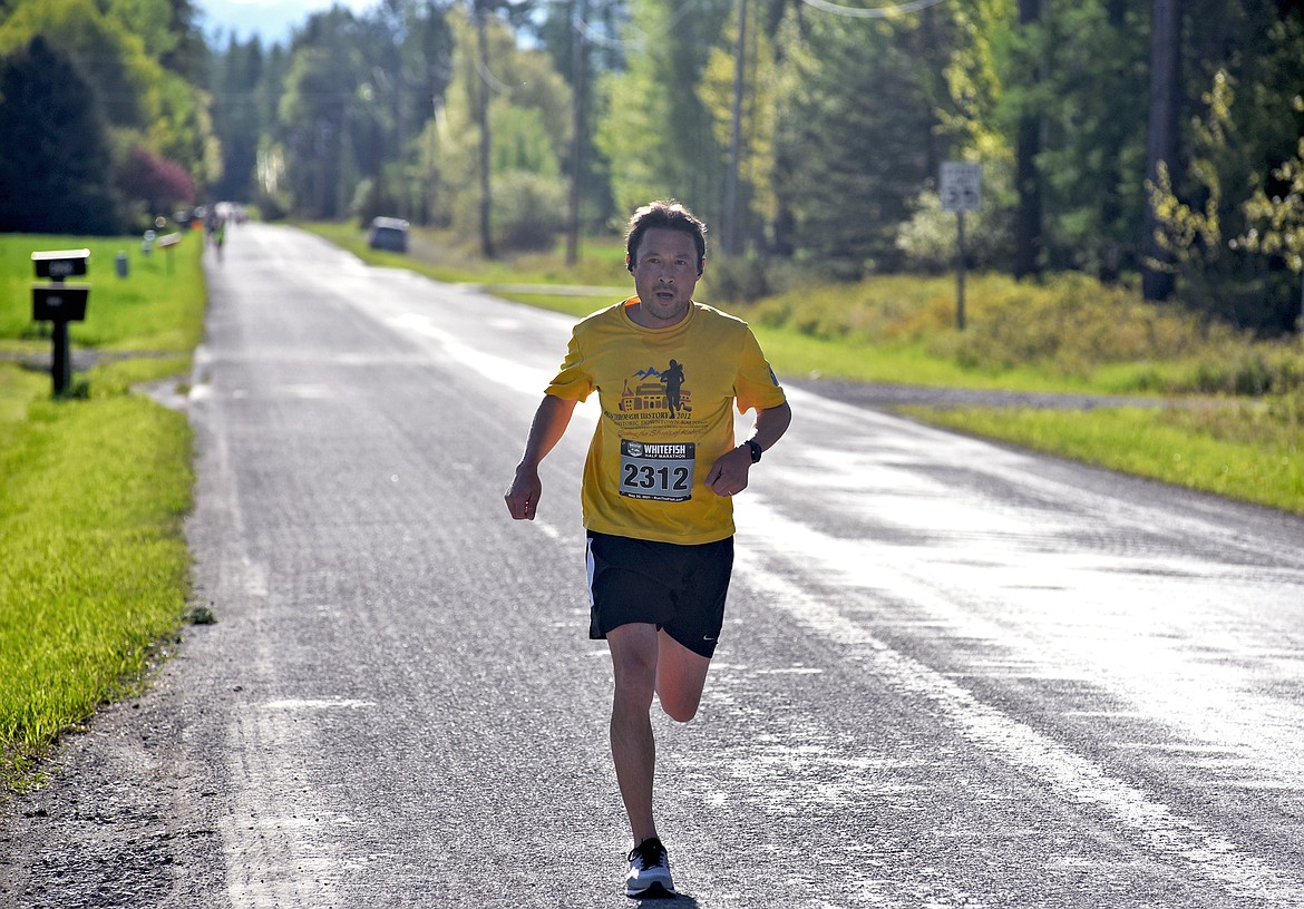 Myers Reece of Kalispell runs down Monegan Road during the Whitefish Marathon on Saturday in Whitefish. He took fourth in the half marathon event. (Whitney England/Whitefish Pilot)