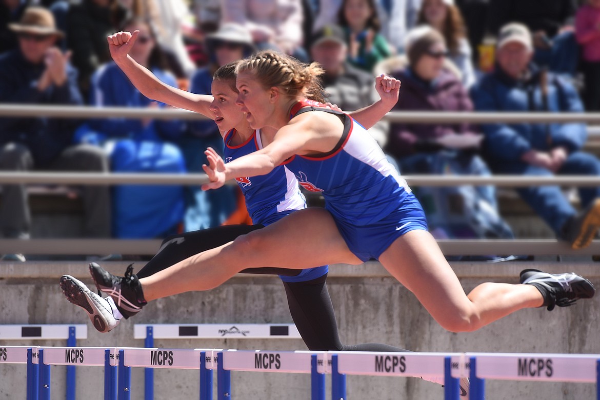 Ashlyn Savik (front) and Ellie Jordt clear the final hurdle in the 300 hurdles in Missoula Saturday.
Jeremy Weber/Bigfork Eagle