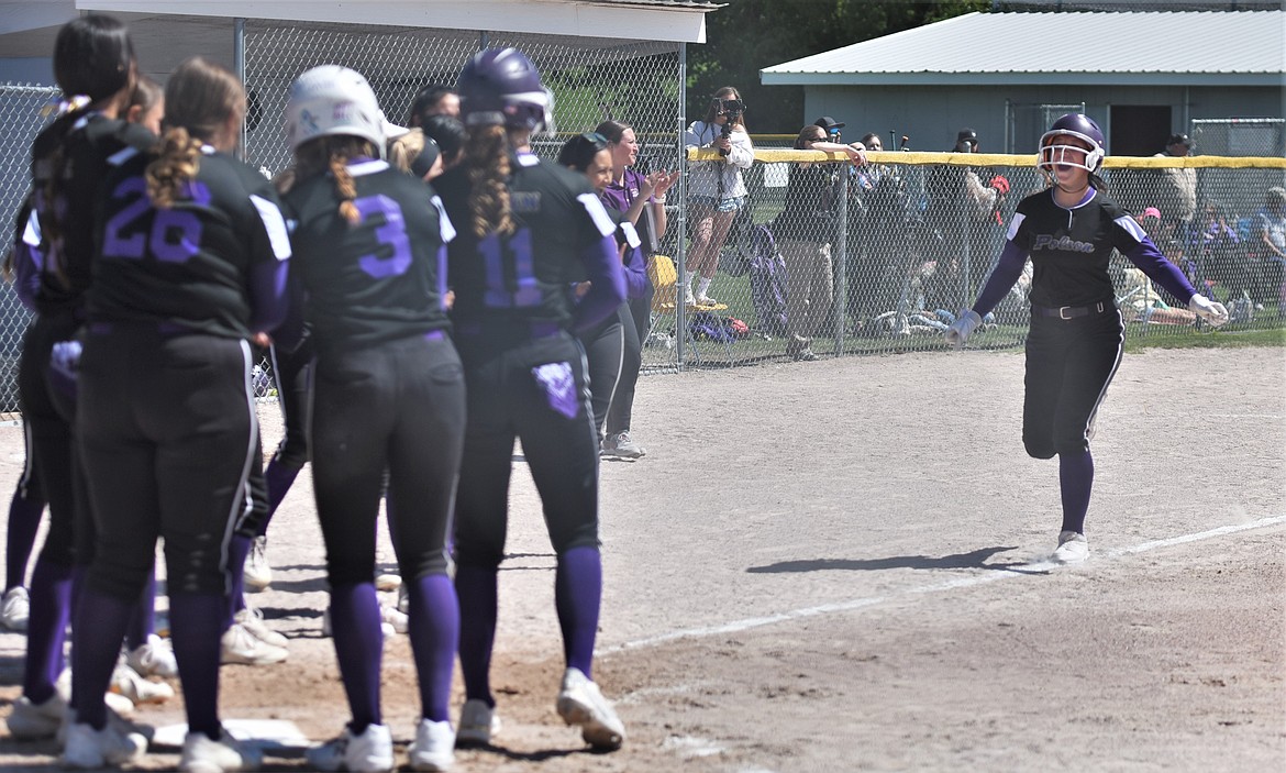 Senior Kobbey Smith is greeted at home plate during her home run trot against Libby. (Scot Heisel/Lake County Leader)