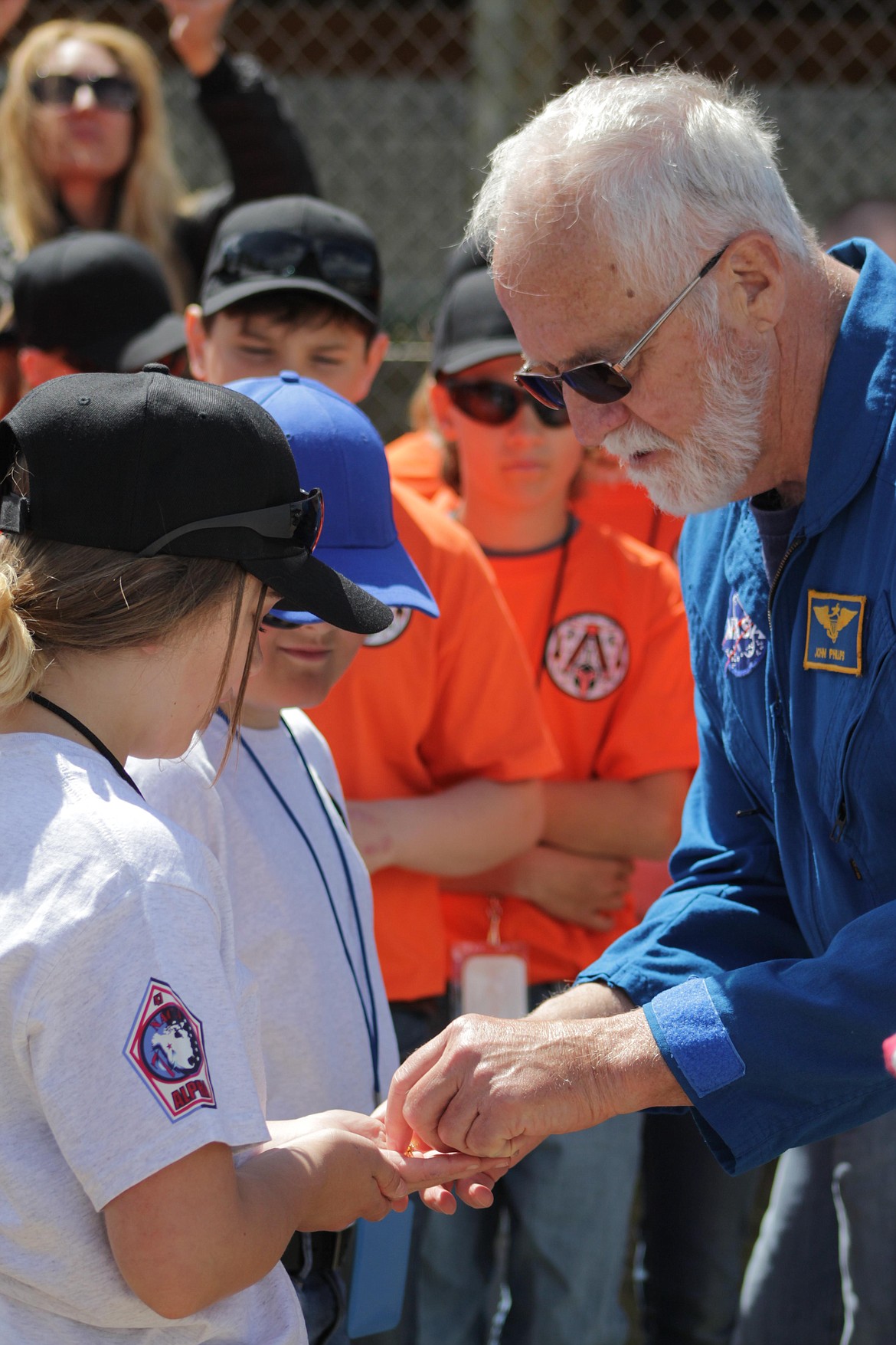 Retired astronaut John Phillips gives awards to students who participated in Space Day activities.