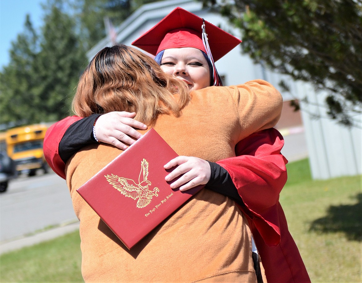 Two Eagle River School graduate Katrina Morigeau gets a hug. (Carolyn Hidy/Lake County Leader)