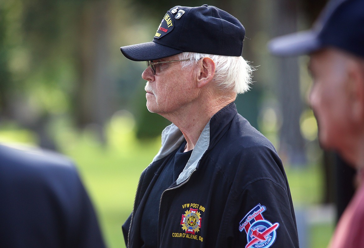 Veteran Bob Martin of Coeur d'Alene watches as flags are distributed at Forest Cemetery Wednesday evening.
