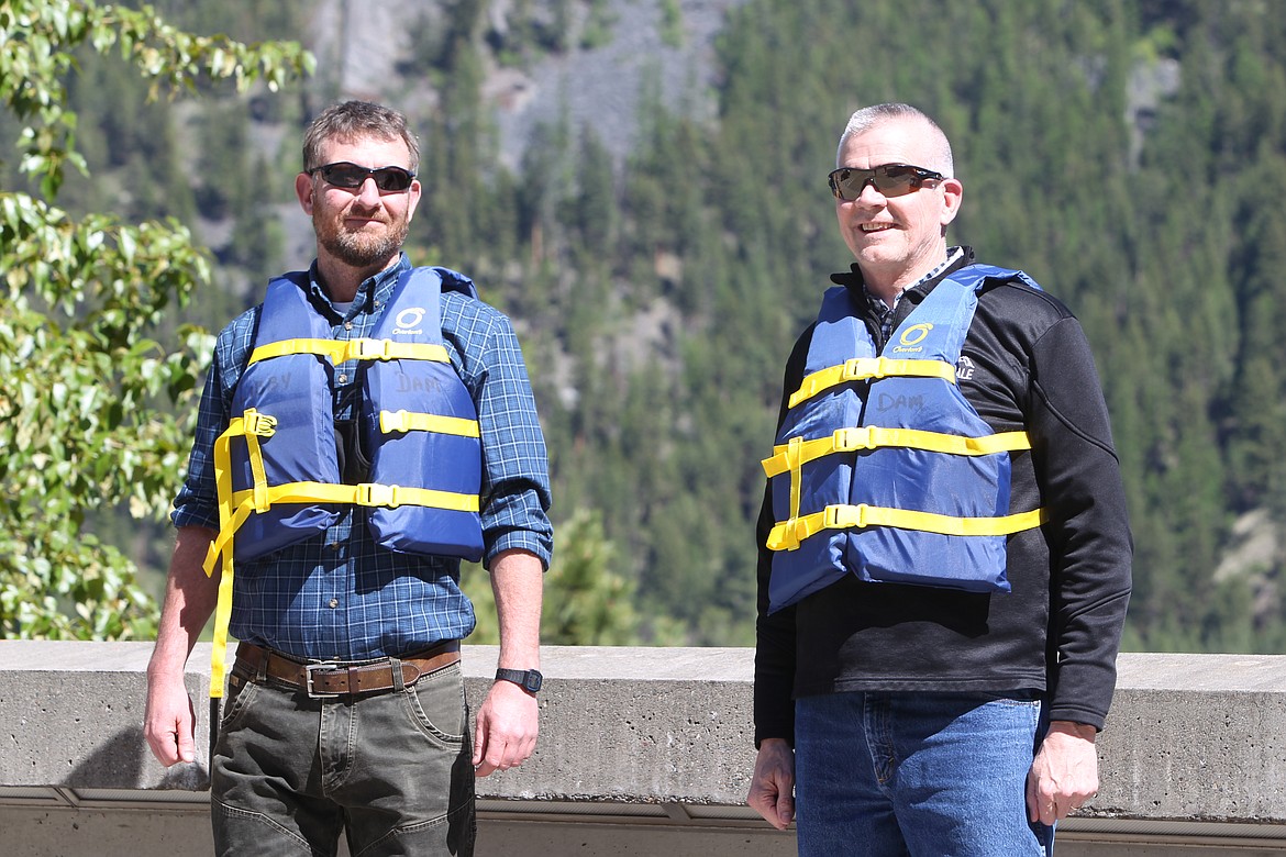 U.S. Rep. Matt Rosendale poses with Josh Baltz, of the U.S. Army Corps of Engineers, with life jackets for National Safe Boating Week. Rosendale received a tour of the Libby Dam on May 22. (Will Langhorne/The Western News)