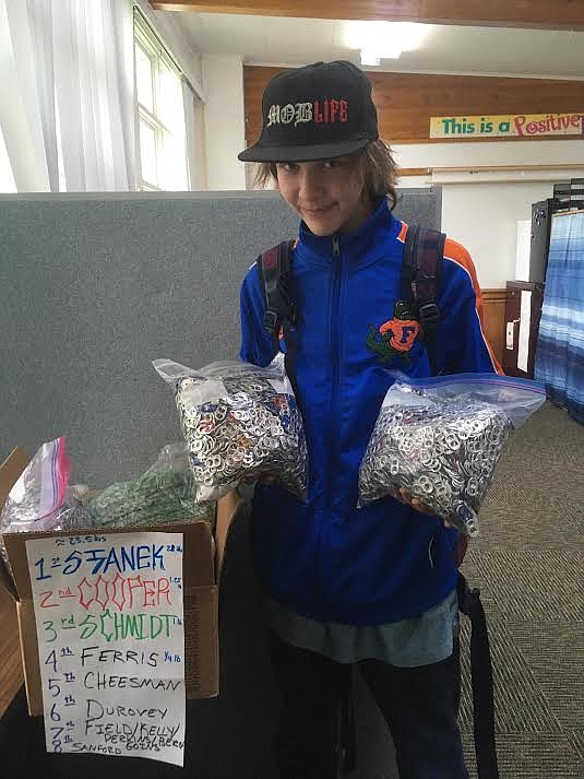 St. Regis High School freshman Wally Crosby holding 23 pounds of aluminum pop tops that will be donated to the Ronald McDonald House. The fundraiser was Wally’s desire to help someone who is fighting cancer. (Monte Turner/Mineral Independent)