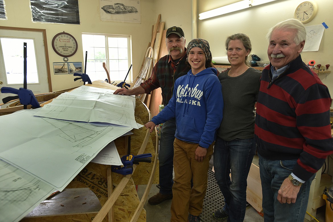 Alex Berry, director of the Montana Wooden Boat Foundation in Lakeside, checks in Wednesday, May 26, 2021, on the progress of the Milone family — Colin, Karen and their son, Jake — who are constructing a Norwegian-style sailboat. (Jeremy Weber/Daily Inter Lake)