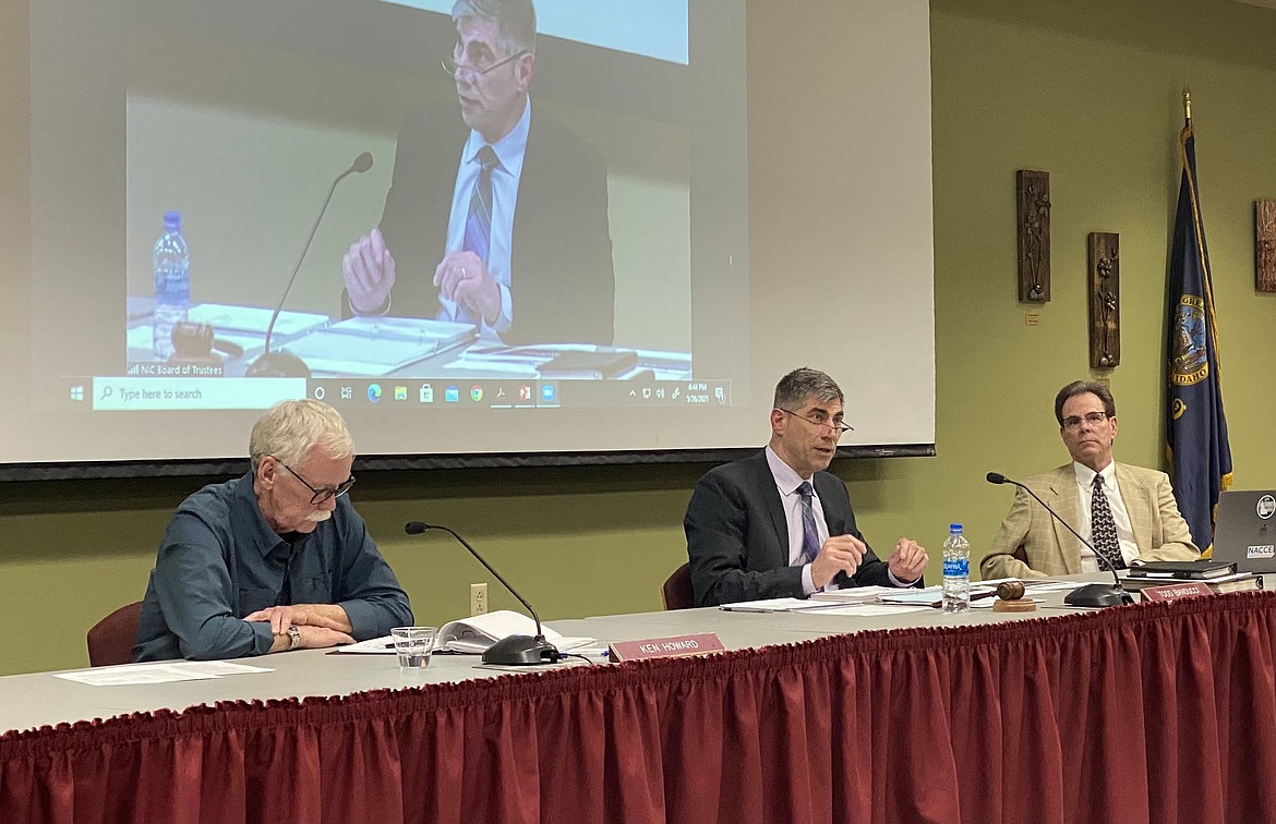 North Idaho College Trustees Ken Howard, far left, and Todd Banducci, middle, sit with college President Rick MacLennan during the monthly board meeting Wednesday night. (MADISON HARDY/Press)