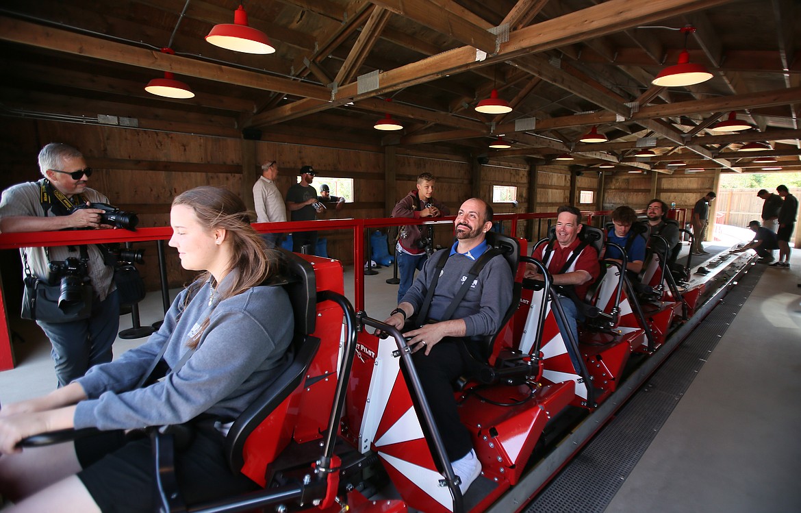 Riders prepare for an exciting aerial journey as they strap in on Stunt Pilot during a Silverwood Theme Park media event Thursday.