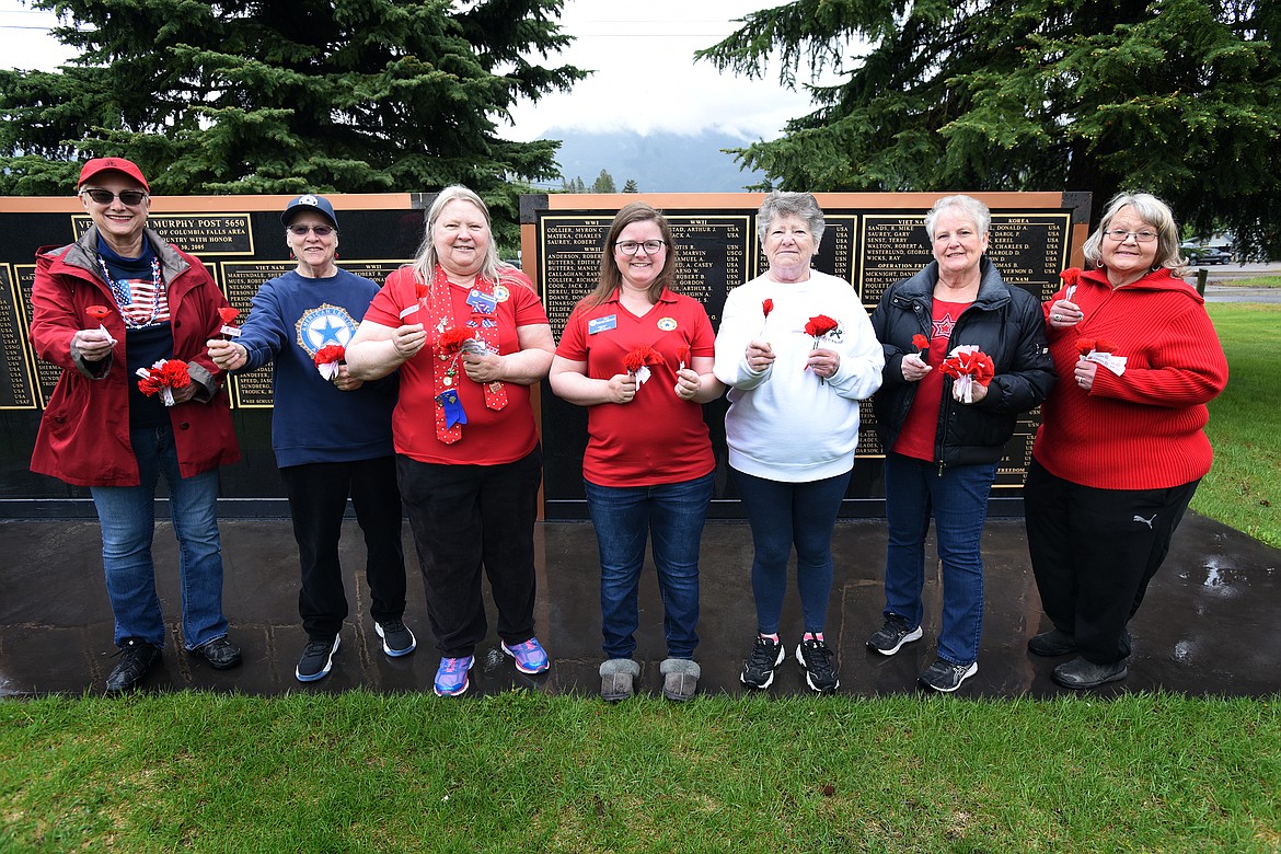 Members of Columbia Falls' American Legion Auxiliary Unit 72 will be at Smith's Food and Drug on Friday, May 28, 2021, to hand out red, crepe-paper poppy flowers as part of National Poppy Day. Pictured, from left, are members April Spotts, Cassandra Thommen, Rosemary Rosenberry, Jill Rosenberry, MaryAnn Jones, Carol Nunnally and Carmela Martin. (Jeremy Weber/Daily Inter Lake)