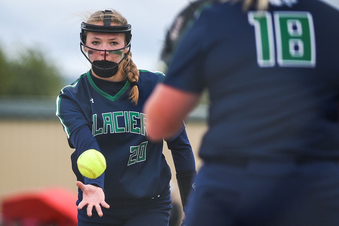 Glacier second baseman Kenadie Goudette (20) flips the ball to first baseman Teagan Powell (18) for an out after fielding a ground ball against Helena during the State Class AA Softball Tournament at Kidsports Complex on Friday. (Casey Kreider/Daily Inter Lake)