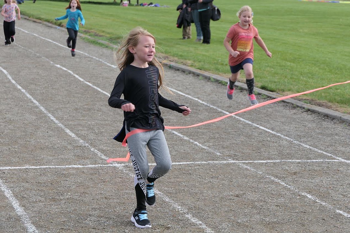 Plains first grade student Kyrie Carr crosses the finish line during a race at track and field day last Wednesday. (Adam Lindsay/Valley Press)