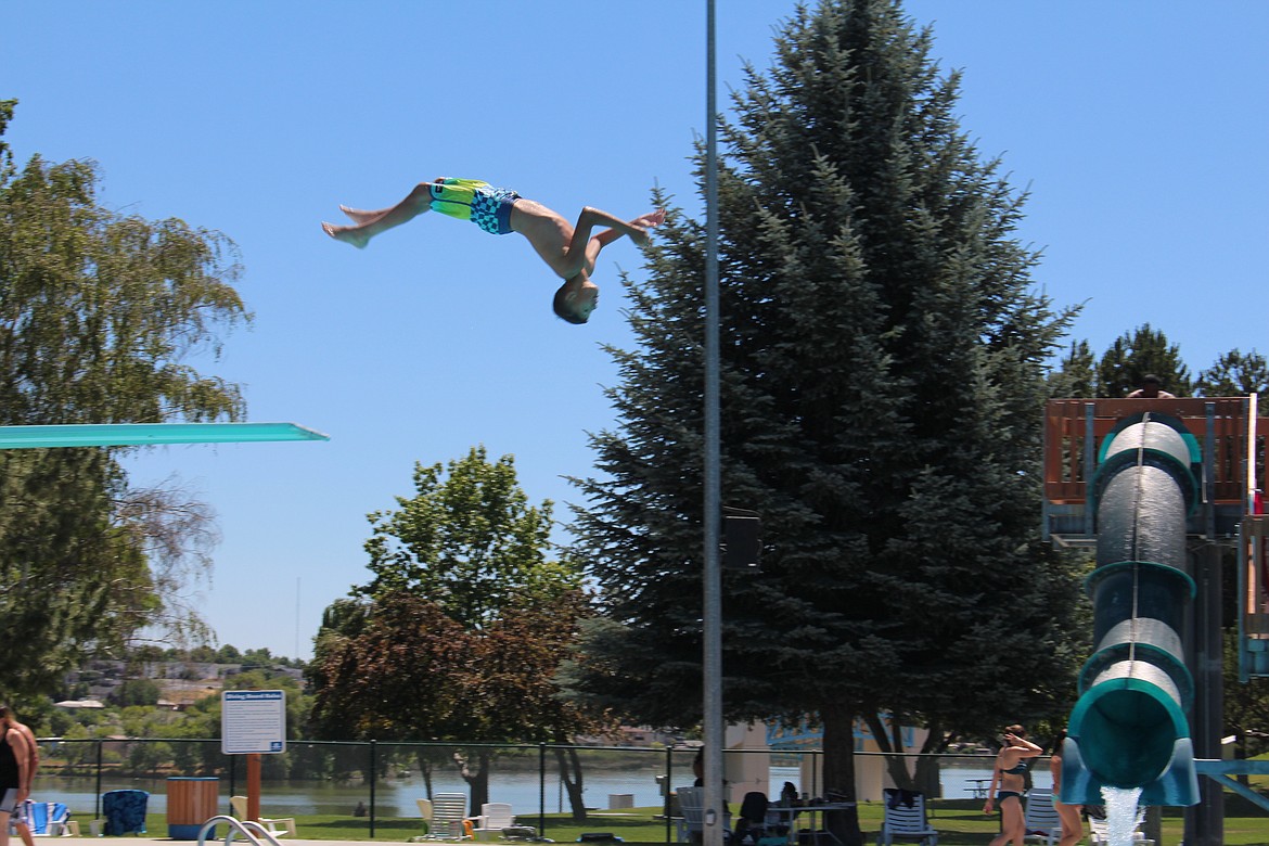 A swimmer flips off the diving board at the Surf ‘n Slide Water Park in Moses Lake.