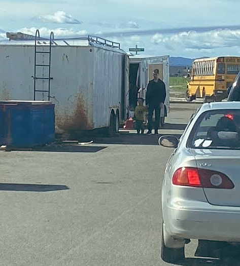 A parent and child walk around a construction trailer Tuesday morning on Moselle Drive adjacent to Northwest Expedition Academy. Parents, contractors and residents are frustrated with the congestion situation that occurs on Moselle, which is the only way into and out of the school.