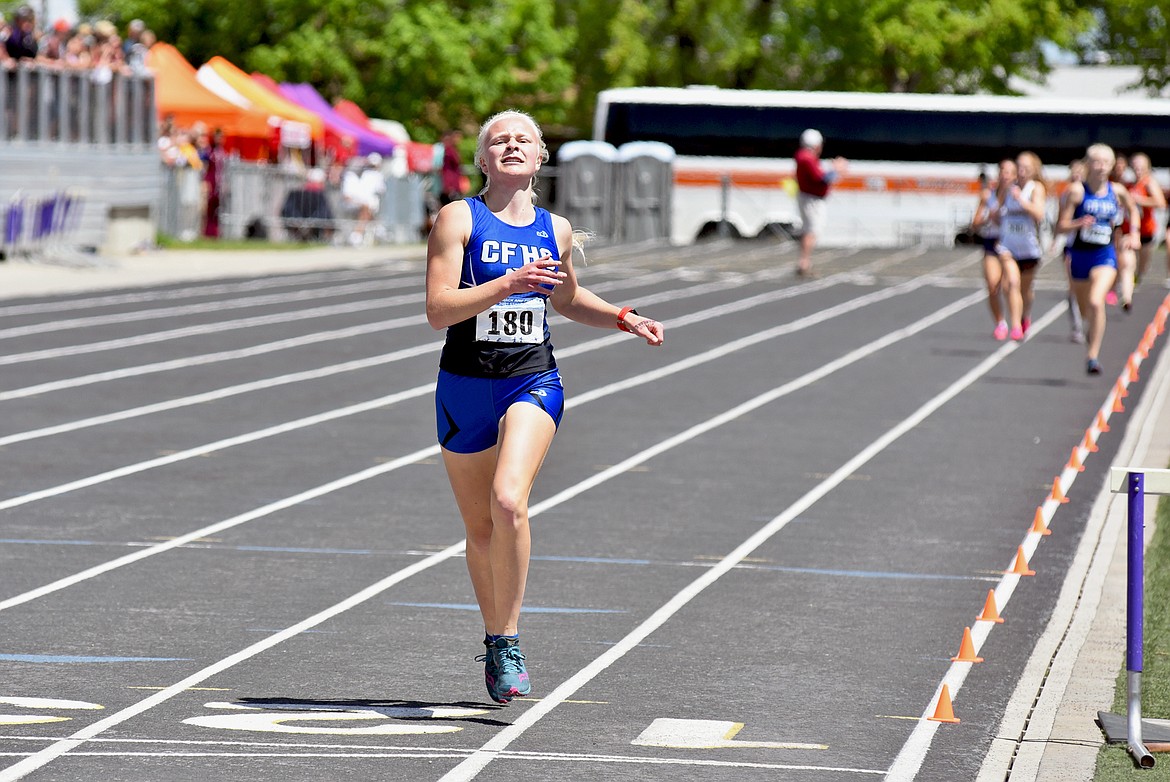 Columbia Falls' Lara Erickson runs to a first-place finish in the Class A girls 1600 meter run finishing 7 seconds ahead of her sister Siri Erickson who came in second place at the Montana Class A-B State Track and Field Meet in Laurel on Saturday. (Whitney England/Whitefish Pilot)