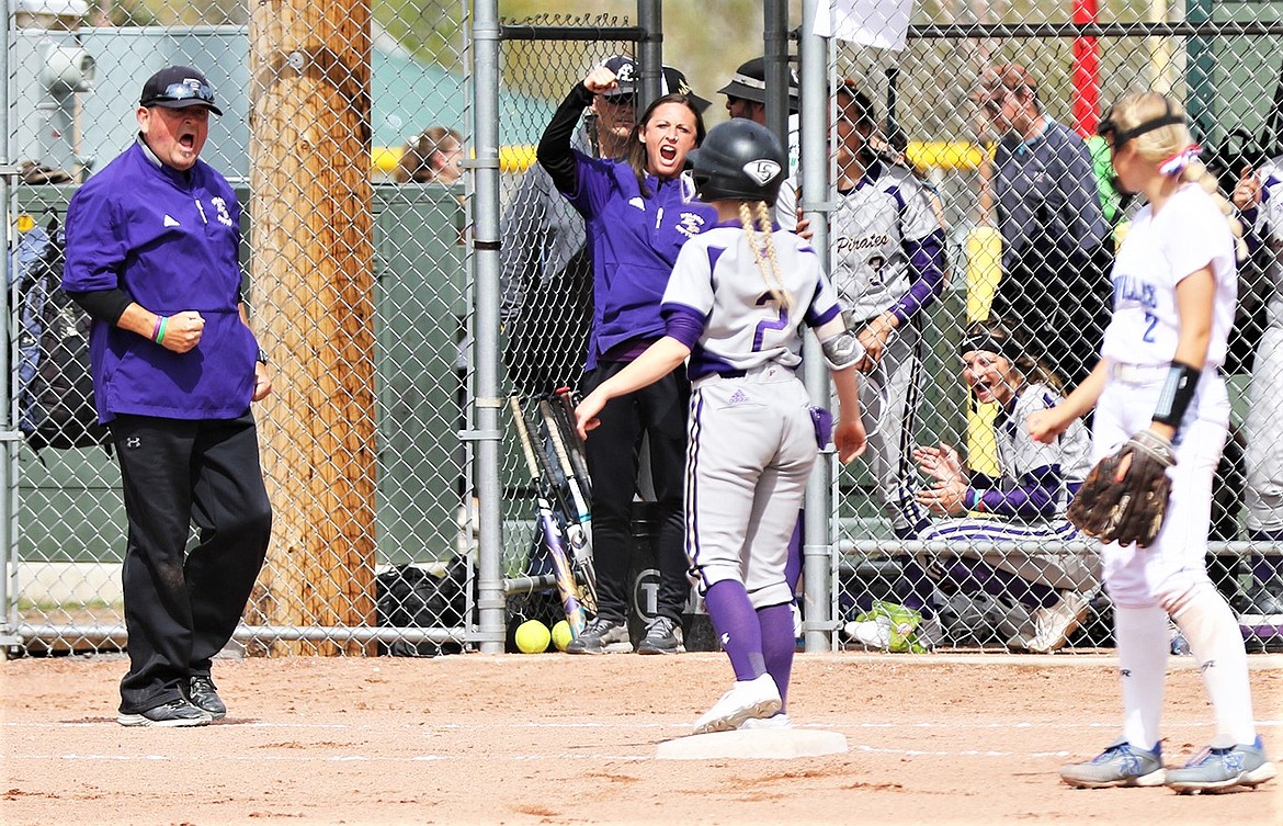 The Polson dugout, including head coach Jami Hanson, left, and assistant coach Jaelin Moldenhauer, center, reacts after Katelyne Druyvestein (2) drove in the Lady Pirates' first run of the state tournament with a triple against Corvallis. (Courtesy of Bob Gunderson)