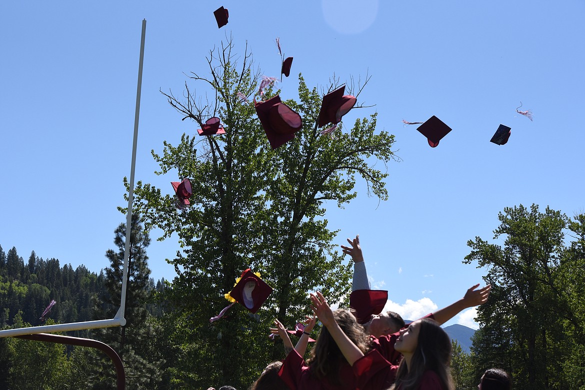 Graduates of Troy High School toss their mortarboards into the air on May 29, 2021. (Derrick Perkins/The Western News)