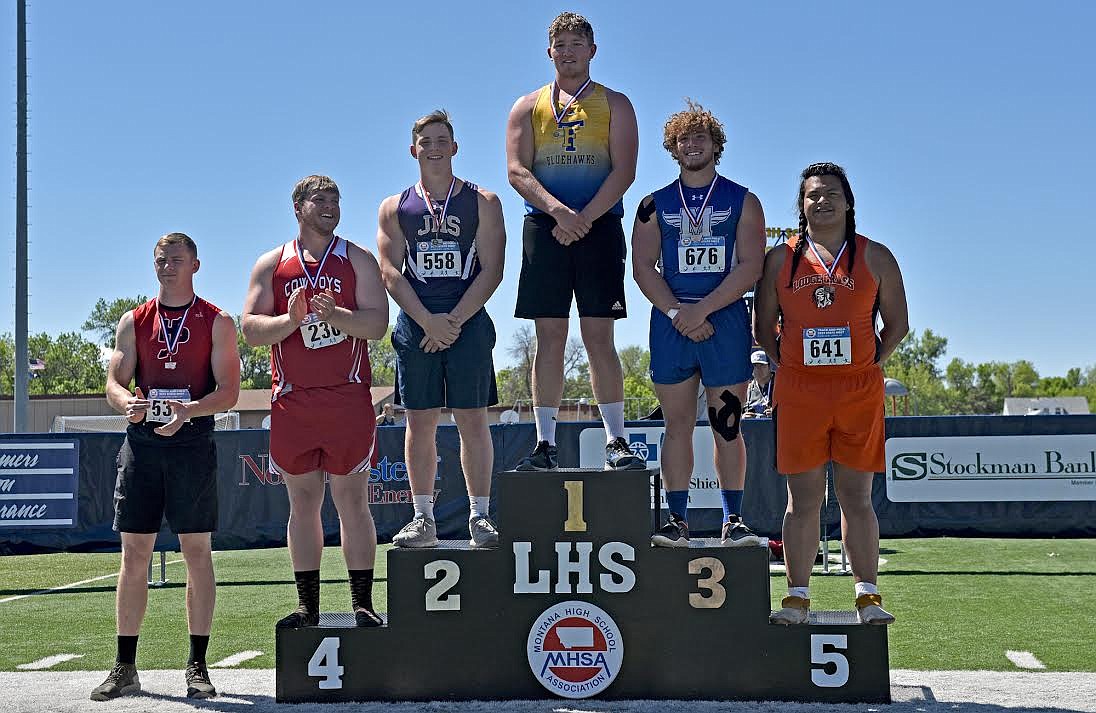 Cody Burk stands atop the podium after winning the Class B shot put state title at the Montana State Track and Field Meet in Laurel on Saturday. (Whitney England/Whitefish Pilot)