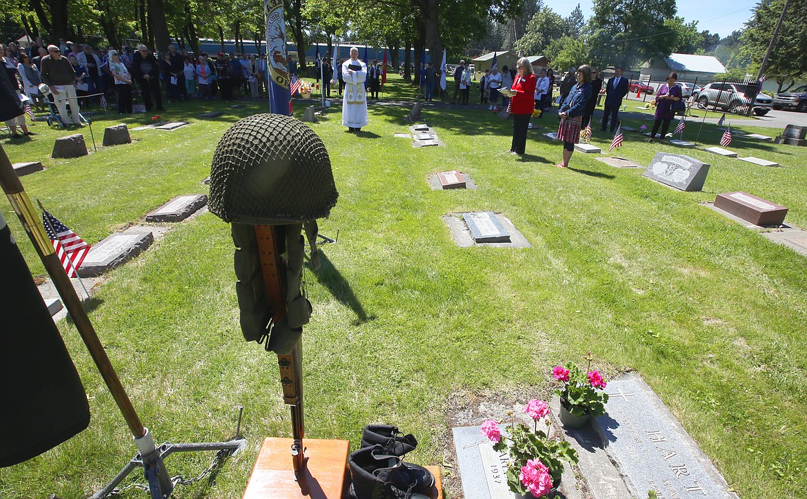 A crowd watches the ceremonies at St. Thomas Cemetery on Sunday.