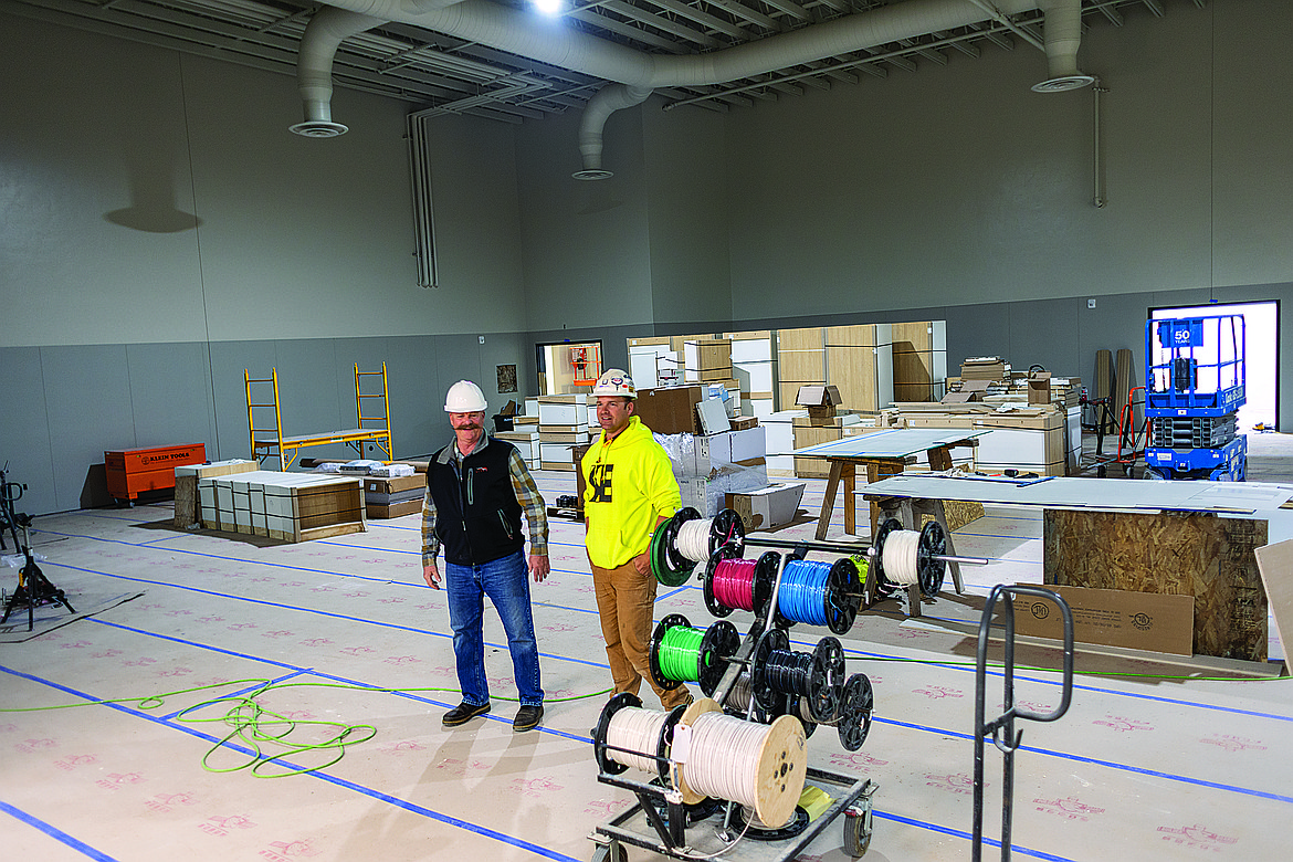 Owners Representative Dave Jolly and Monty Moultray in the new cafetorium of Ruder Elementary. (Chris Peterson/Hungry Horse News)