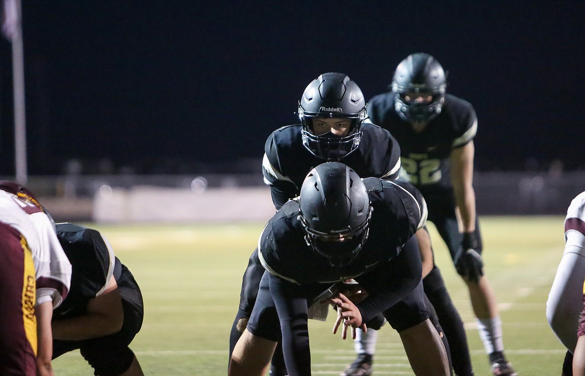 Royal High School senior quarterback Caleb Christensen under center in his final home game this season gets set to hike the ball against Moses Lake High School in April.