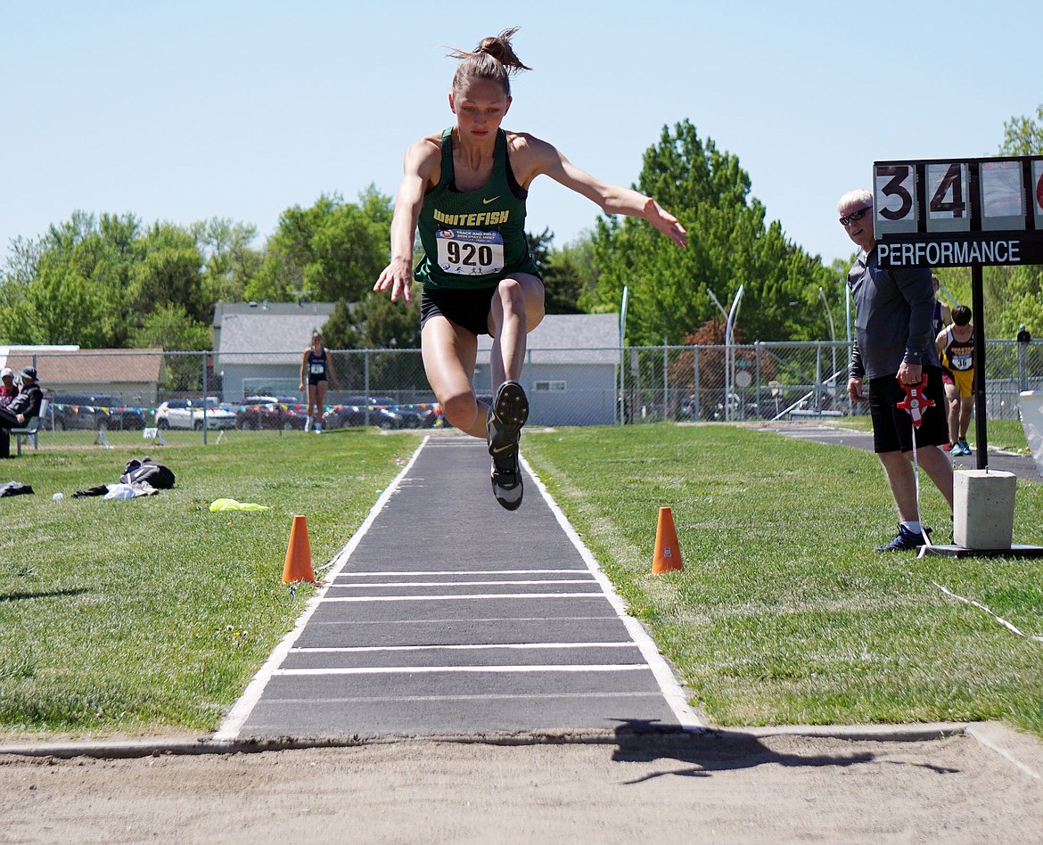 Whitefish’s Erin Wilde competes in the triple jump at the Class A state track meet at Laurel. (Matt Weller photo)