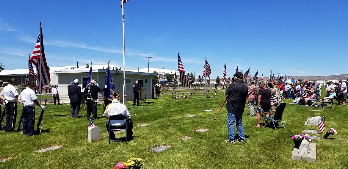 Quincy Chief of Police Kieth Siebert (at left) speaks at the Memorial Day service at the Quincy Valley Cemetery on Monday.