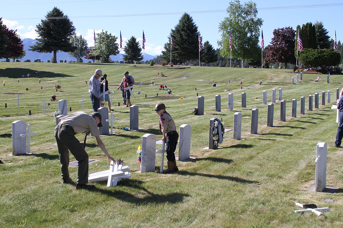 Members of Boy Scouts Polson Troop 1947 were among those working with Honor Guard and others Saturday morning placing approximately 500 flags and crosses on military headstones at Lakeview Cemetery in Polson. (Courtesy of Sheri Connors-David)