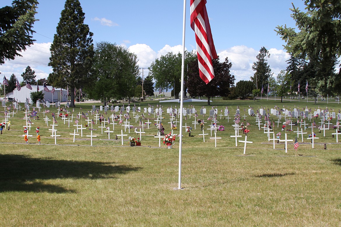 Members of Boy Scouts Polson Troop 1947 were among those working with Honor Guard and others Saturday morning placing approximately 500 flags and crosses on military headstones at Lakeview Cemetery in Polson. (Courtesy of Sheri Connors-David)