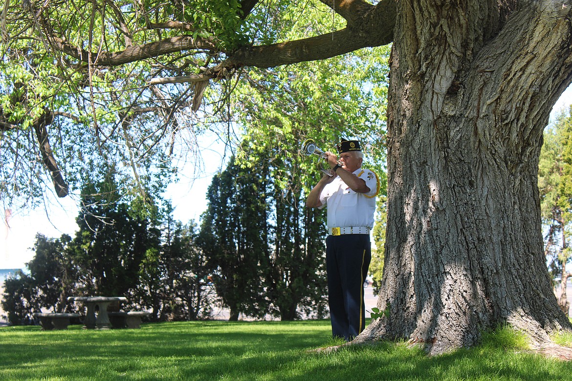 First Vice Commander Rex Rogers of American Legion Joe R. Hooper Post 209 plays "Taps" for the Memorial Day service at the 87 Fallen Heroes Memorial in Moses Lake.