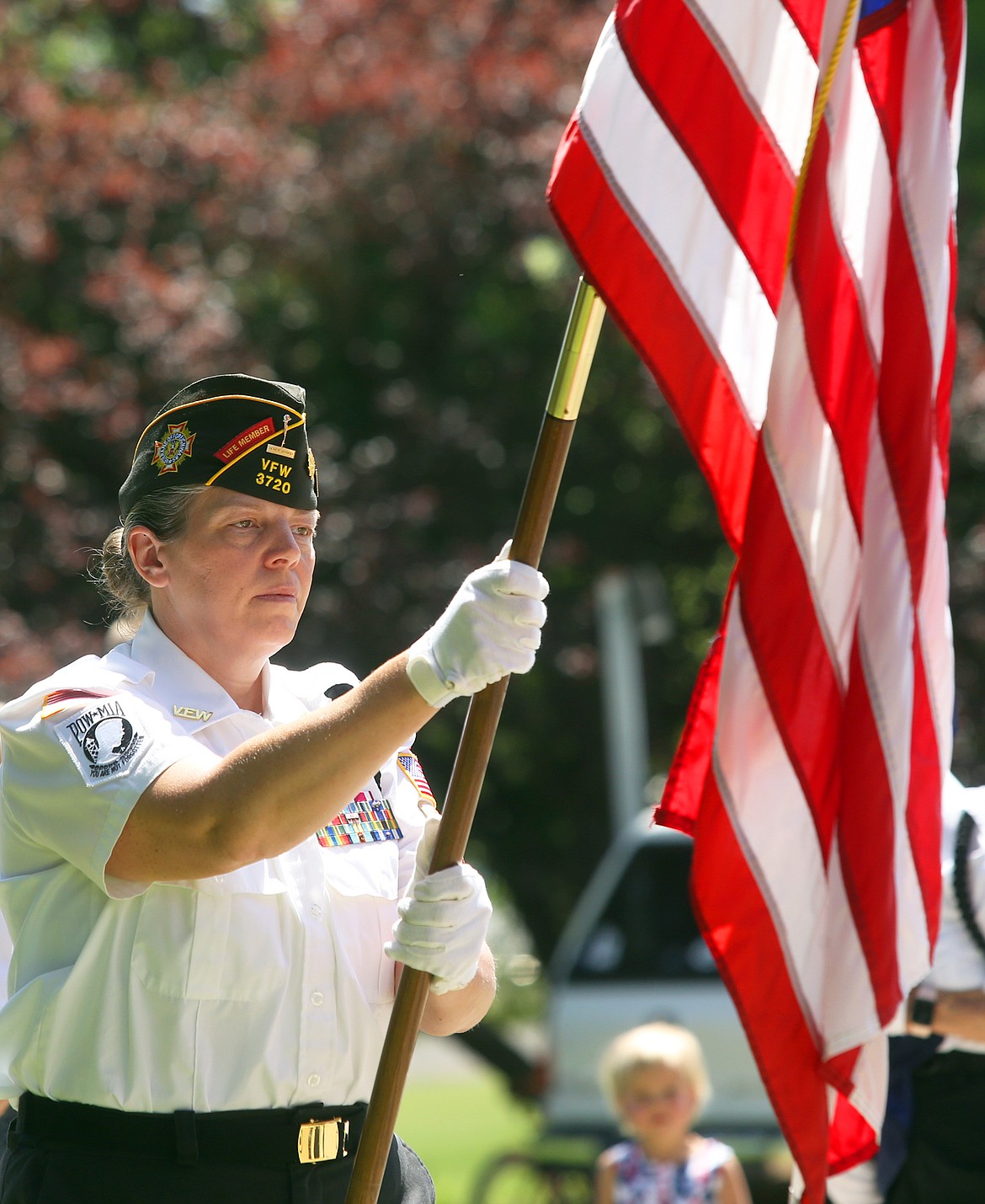 Retired Major Christina Kirkland carries the flag with the Color Guard on Monday at McIntire Family Park.