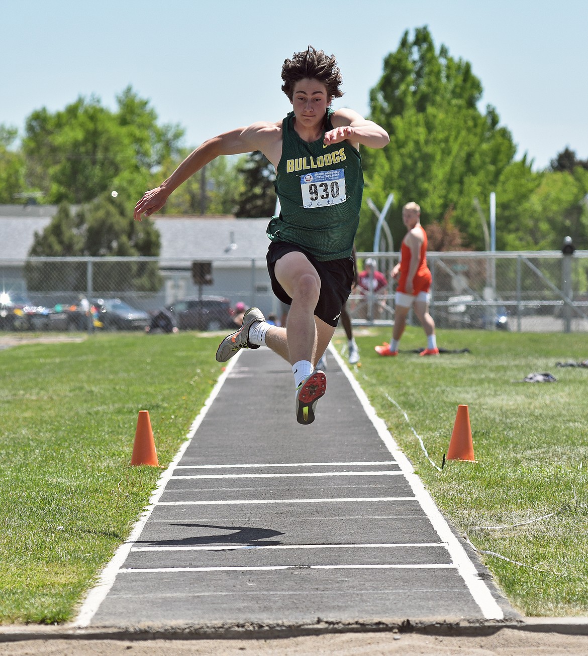 Bulldog Gabe Menicke flies in the Class A boys triple jump final to take the state title in the event at the Montana Class A-B State Track and Field Meet in Laurel on Saturday. (Whitney England/Whitefish Pilot)