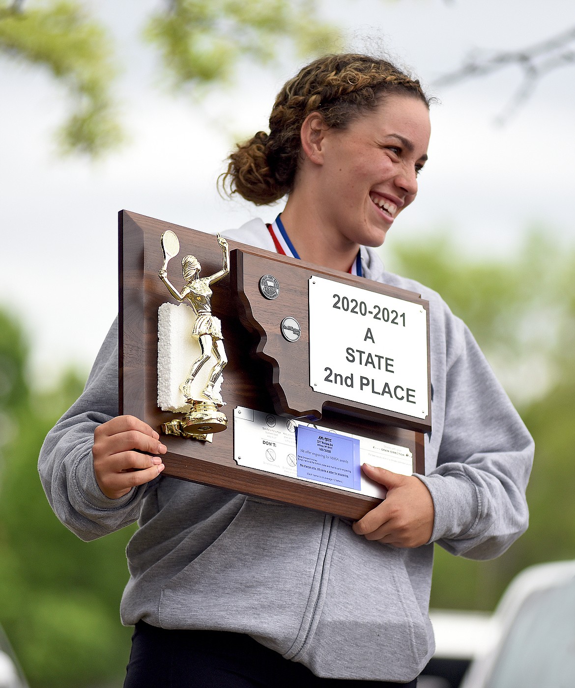 Whitefish senior Gracie Smyley accepts the second-place team award following the State A tennis tournament in Billings on Friday. (Whitney England/Whitefish Pilot)