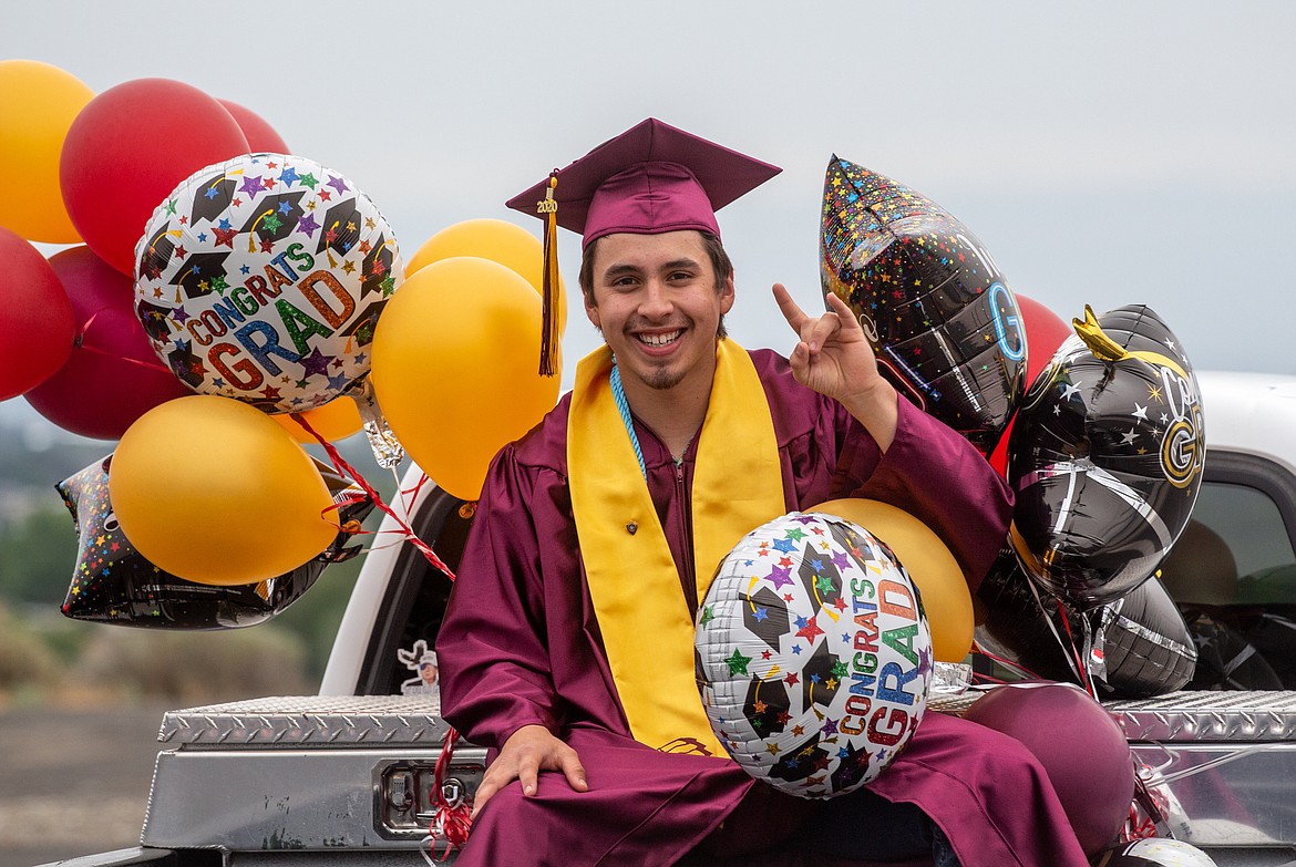 A Moses Lake High School senior riding the 2020 graduation car parade. Moses Lake has opted for a drive-thru graduation, but other schools will be holding ceremonies in person.