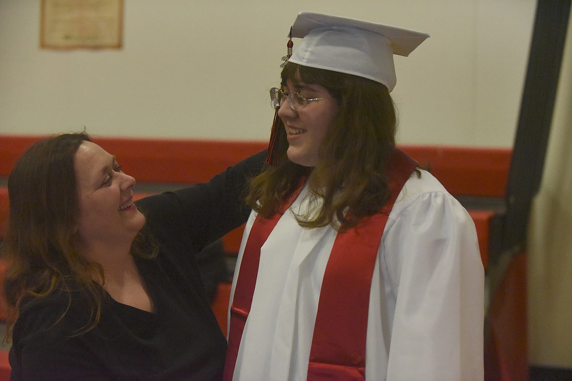 Lorrena Bishop helps her daughter, Hannah, with her cap as they prepared for graduation on Saturday, June 2 at Hot Springs High School. She is the daughter of Chris and Lorrena Bishop. Hannah, who is Montana Miss
Amazing Teen Queen, plans to represent the state of Montana at the Miss Amazing Nationals in Nashville, Tennessee. Miss Amazing is a state pageant for women and girls with disabilities. (Scott Shindledecker/Valley Press)