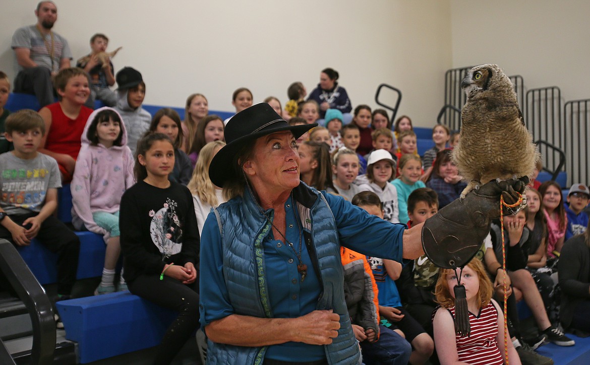 Tigger, a blind great horned owl, sits on Janie Veltkamp's glove during a Birds of Prey Northwest program Friday at Northwest Expedition Academy. The program was paid for by a grant from the Idaho STEM Action Center.