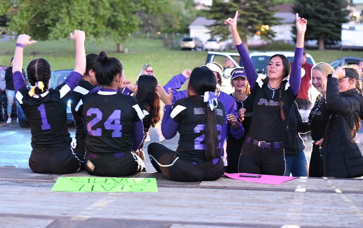 The Lady Pirates cheer from the back of a flatbed truck at the Polson High School parking lot Saturday night. (Scot Heisel/Lake County Leader)