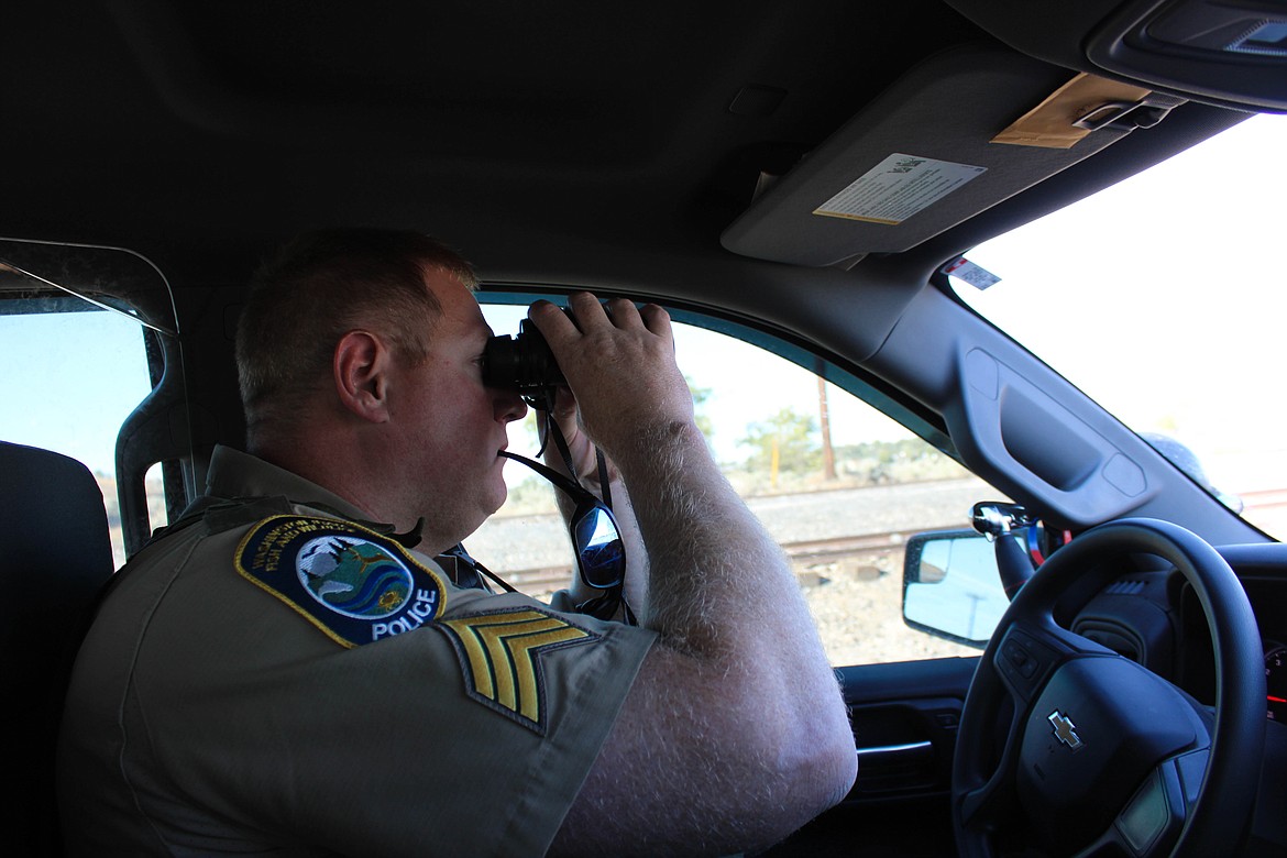 Sgt. Chris Busching scouts out anglers near a Moses Lake railway on Friday.