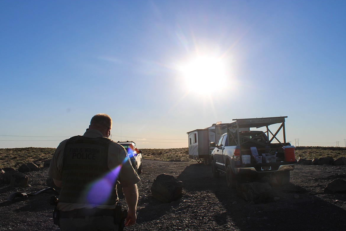 Sgt. Chris Busching talks to campers near the Crab Creek Overlook outside of Moses Lake on Friday.